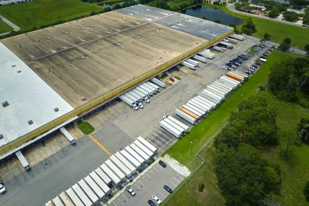 Aerial view of large commercial loading bay with many delivery trucks