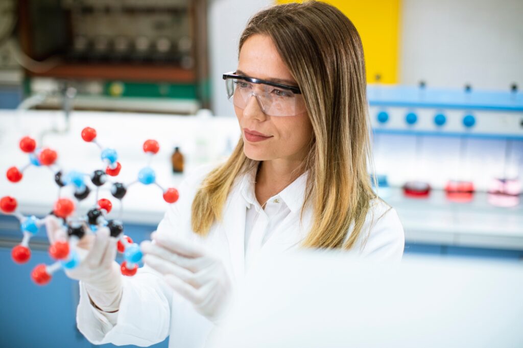 Female chemist hold molecular model in the lab